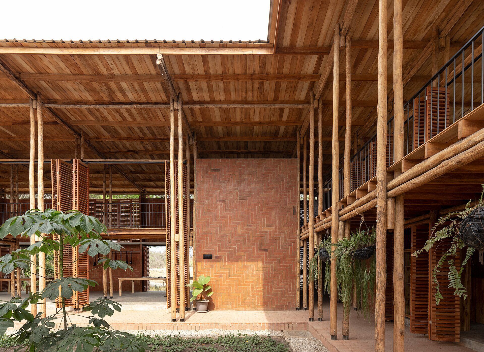 Open air building constructed of red brick and wood.