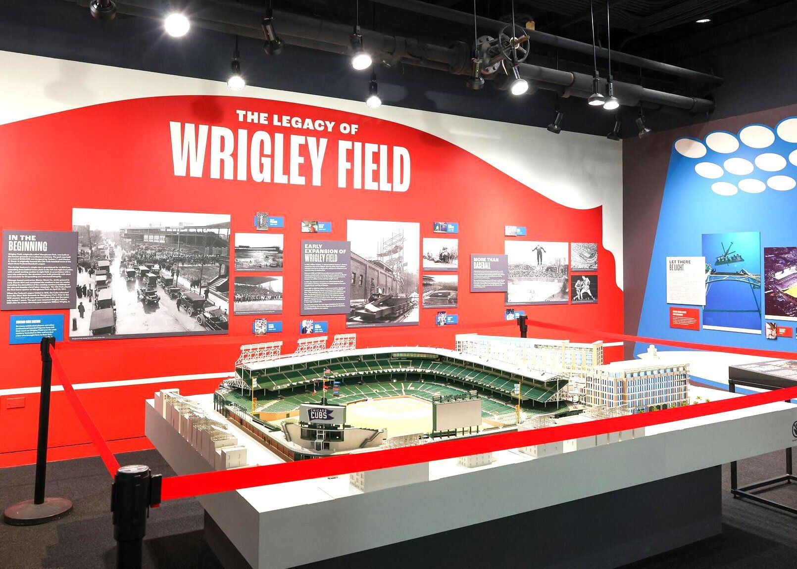 Inside an exhibit space with a wall of images and content