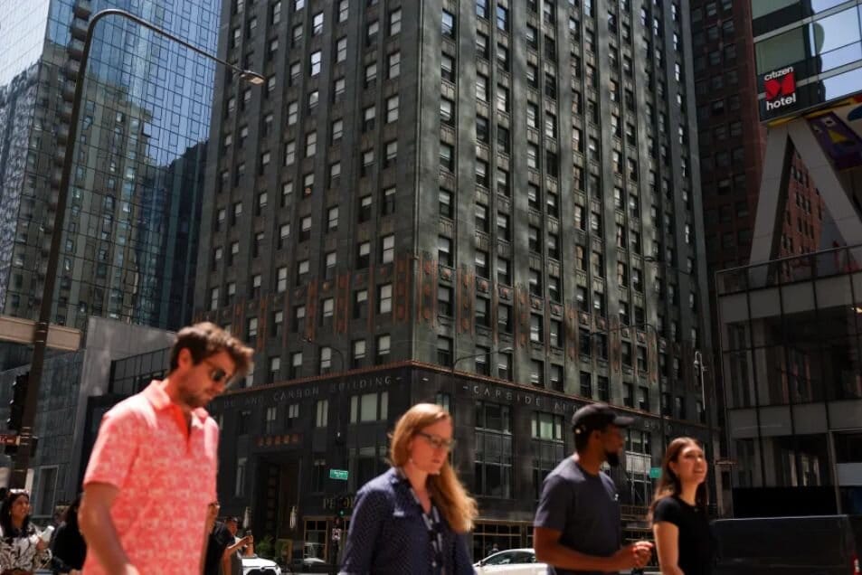People walk past the Carbide & Carbon Building in Chicago’s Loop, July 29, 2025, where the Pendry Hotel is located.