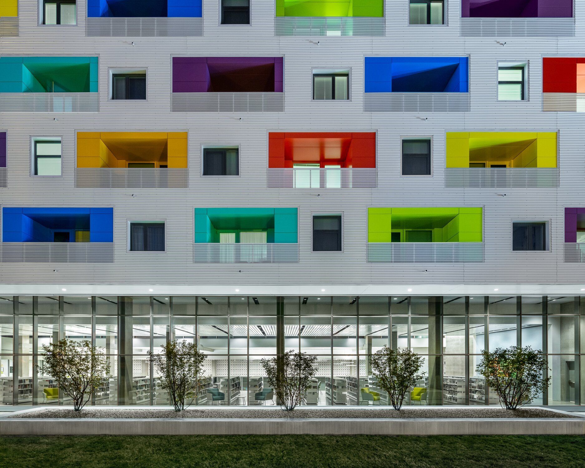 Facade of the Independence Library, a gray building with colorful windows