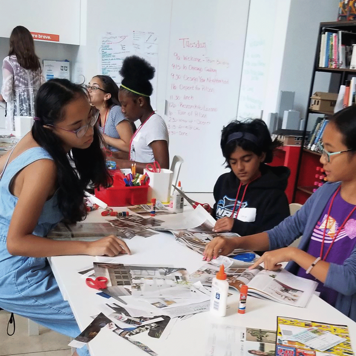 A diverse group of girls working on a project together