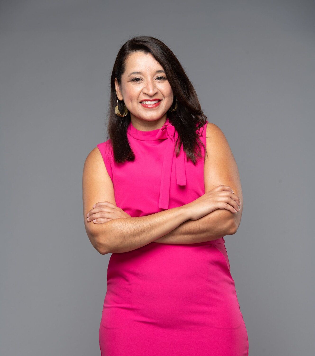 A woman sitting on a lounge chair outside.