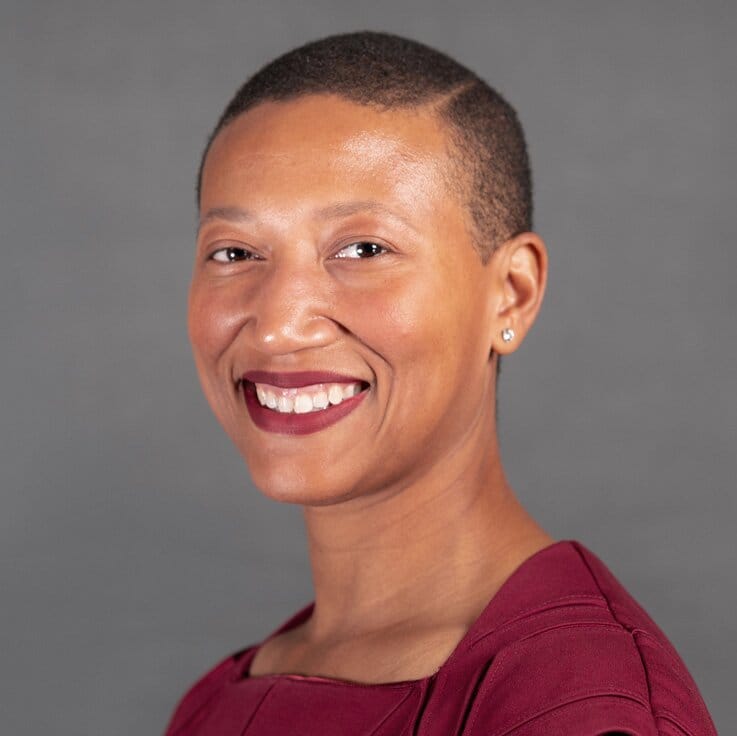 Woman with a short haircut in a burgundy top