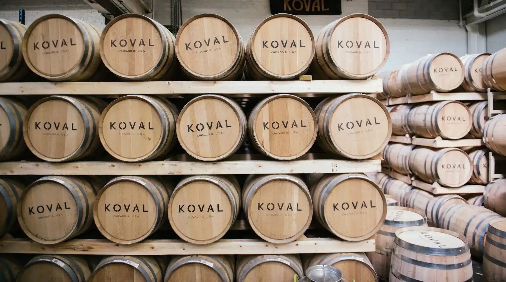 Image of barrels stacked on shelves with the Koval logo facing outward
