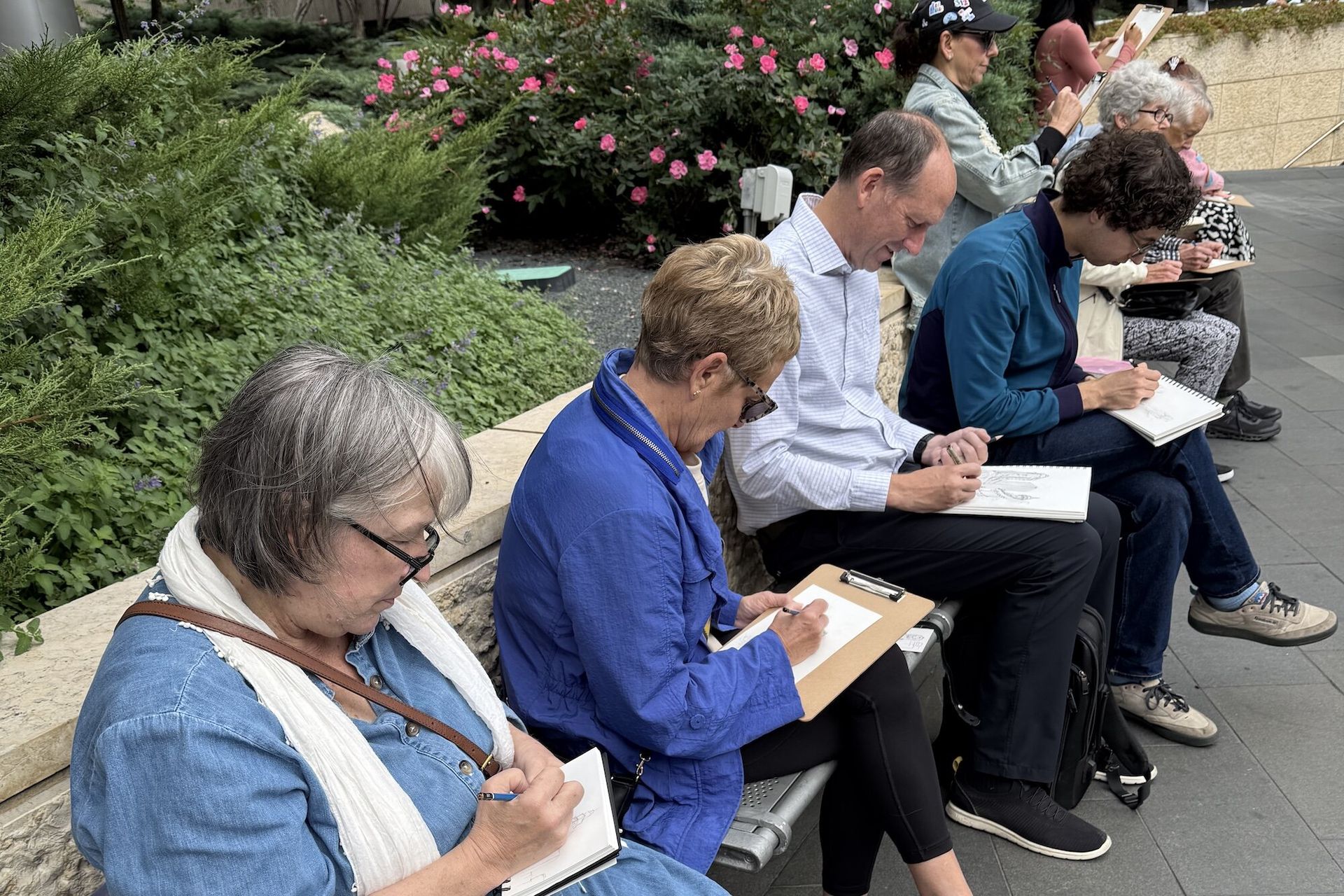People looking down at art sketching materials