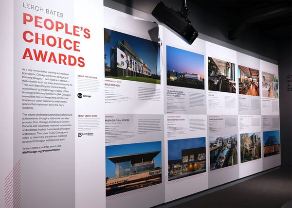 Inside an exhibit space with a wall of images and content