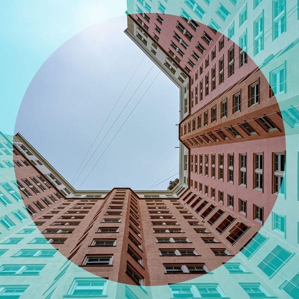 Man standing and facing away from the viewer looking at a wall of illustrations of different locations.