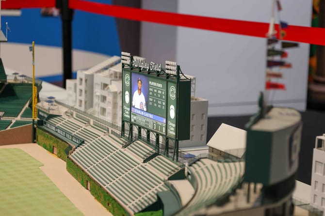 Image of a miniature model of a baseball stadium looking at the scoreboard from the side.