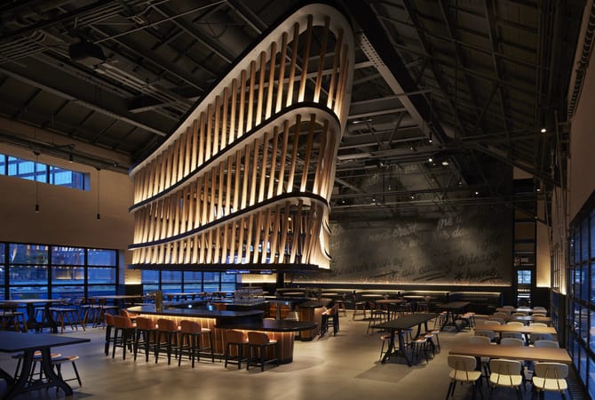 Restaurant interior with a dramatic hanging sculpture above a bar.