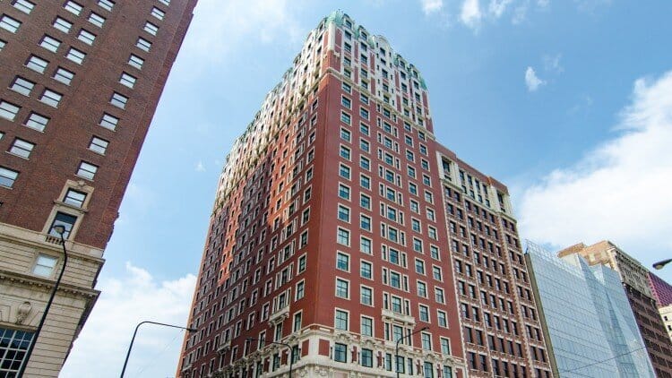 Tall brick building with a green roof