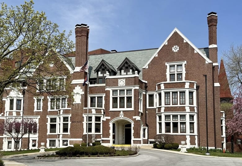 Red brick building with white trim on a sunny day.