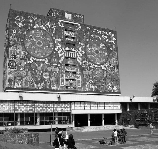black and white photo of a building with a mural on the side of it.
