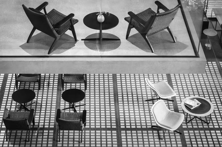 Black and white image of chairs and tables taken from above