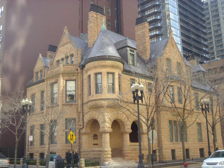 Exterior view of gothic building on street corner with yellow brick