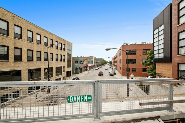 View from elevated walking path onto city street. 