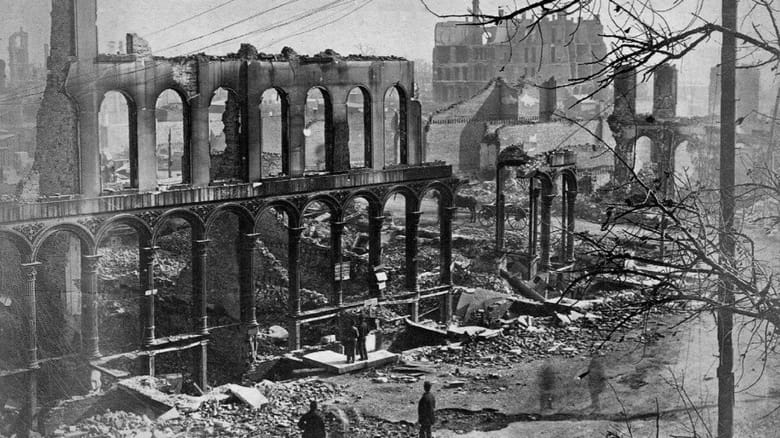 Black and white image of the wreckage of a building after a fire. 