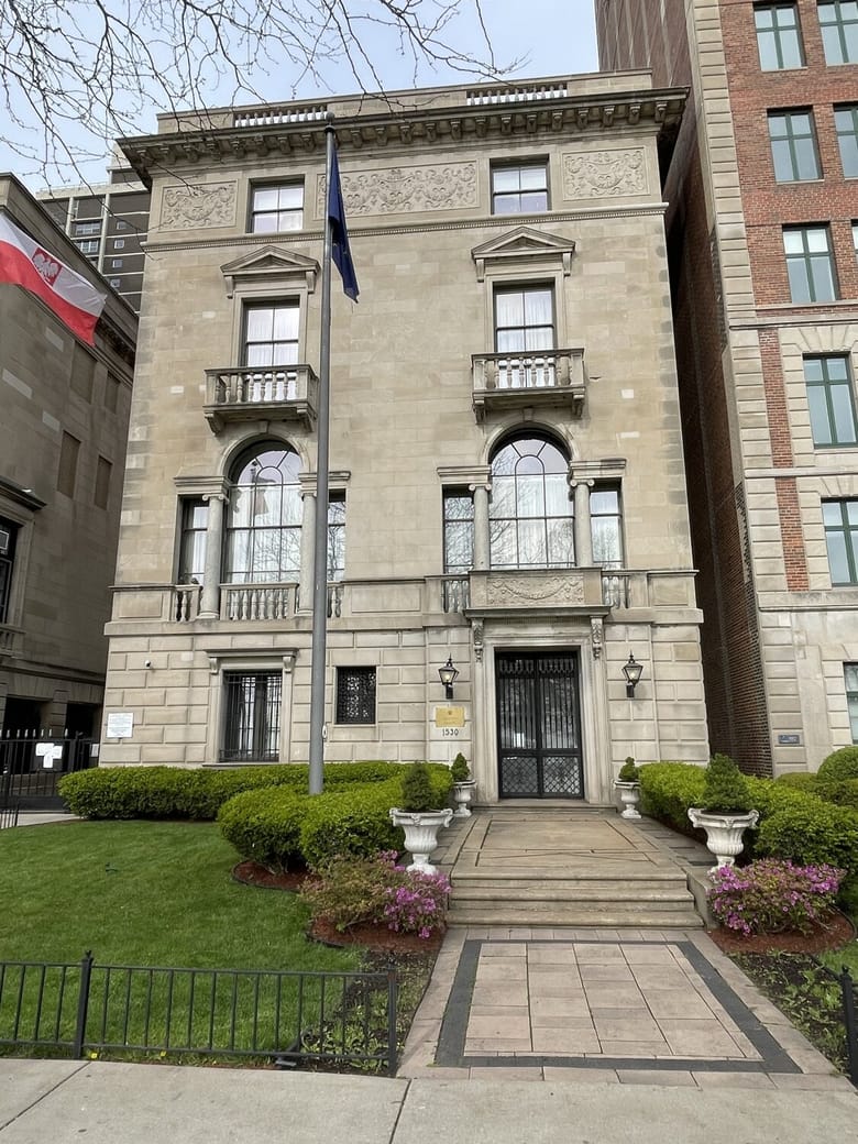 4 story grey stone rectangular building.