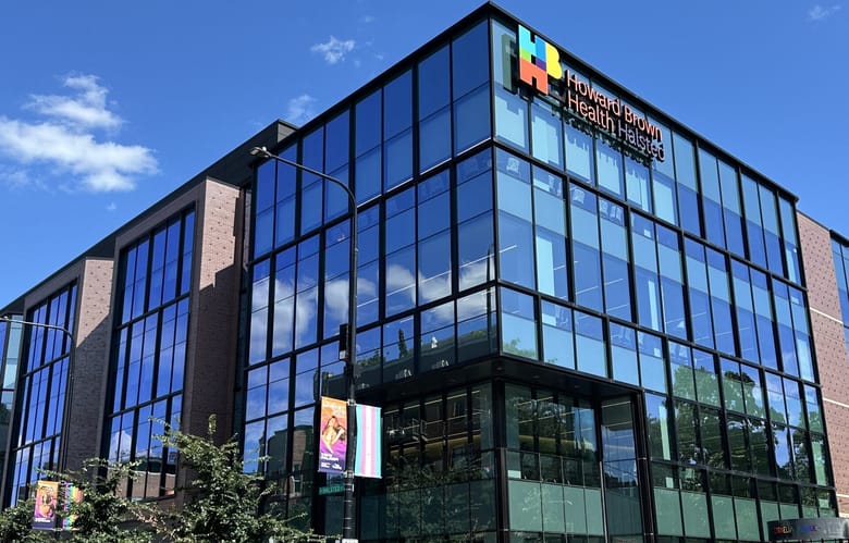A building made of glass on a sunny day.