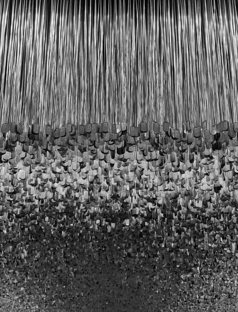 Many different dog tags layered together from the ceiling.