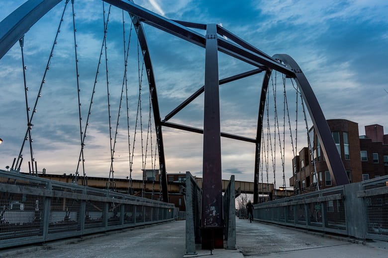 Evening view of pedestrian bridge with night sky. 