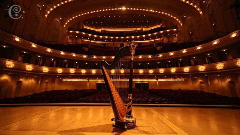 View from the stage of a concert hall with a harp in the middle of the stage and looking out into the empty seats. 