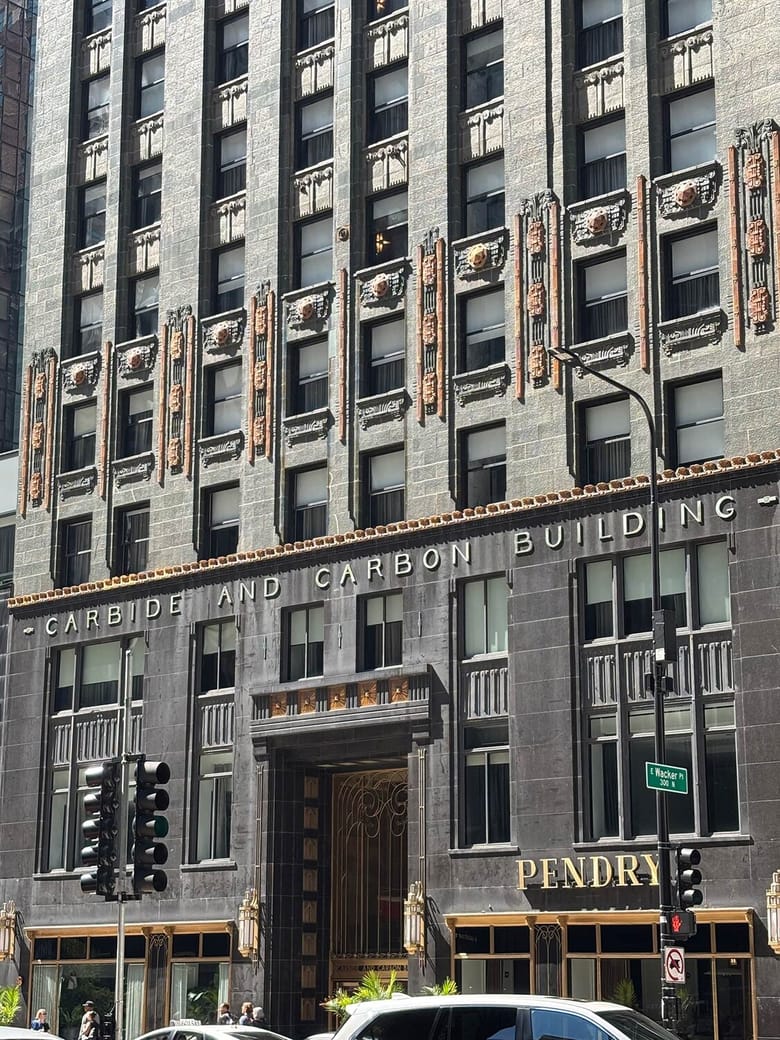 Exterior shot of a greenish grey skyscraper with gold trims