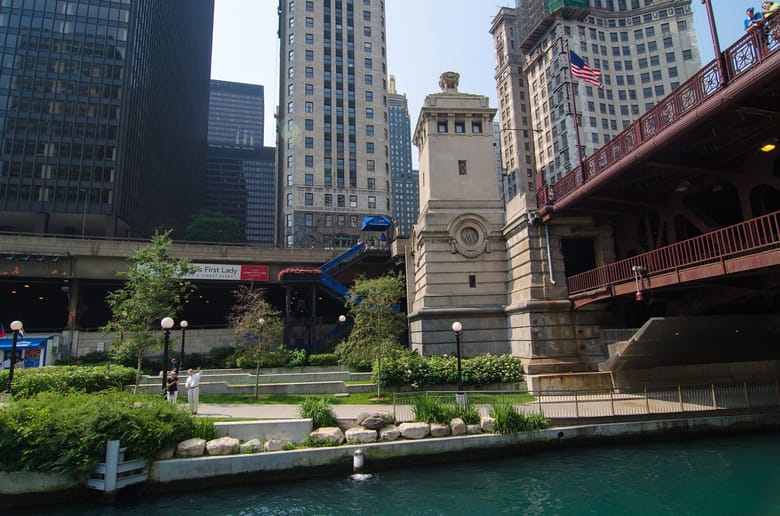 View of lower level beneath bridge near busy city street.