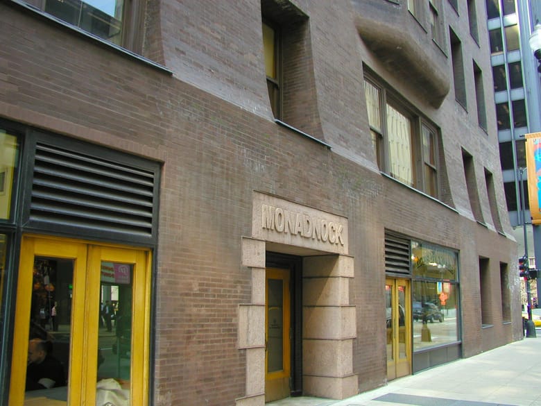Exterior of brick building with yellow trim