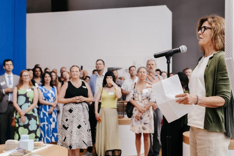 Image of a woman talking to a group of people