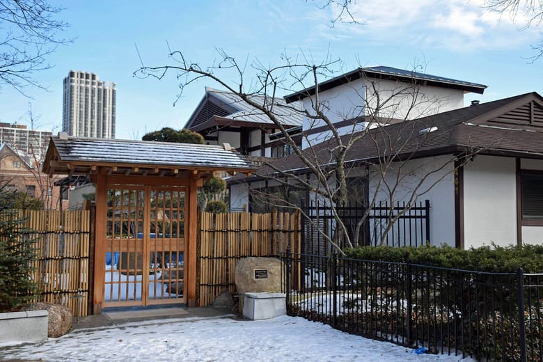 Exterior view of modern temple with pitched black roof.
