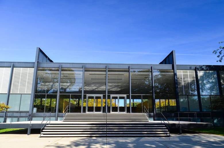 Crown Hall, iconic modernist architecture by Mies van der Rohe, featuring a minimalist design with steel framing and glass walls.