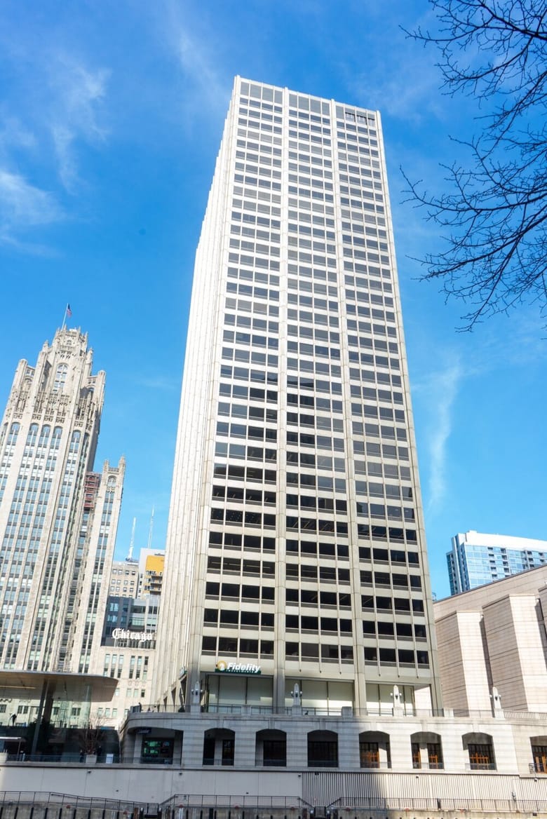 A photo of a white building and a bright blue sky.