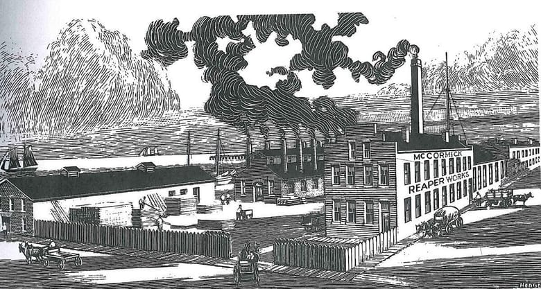 Black an white illustration of a factory building with tall smoke stacks and a fence around the front. Text on the side of the building reads "McCormick Reaper Works"