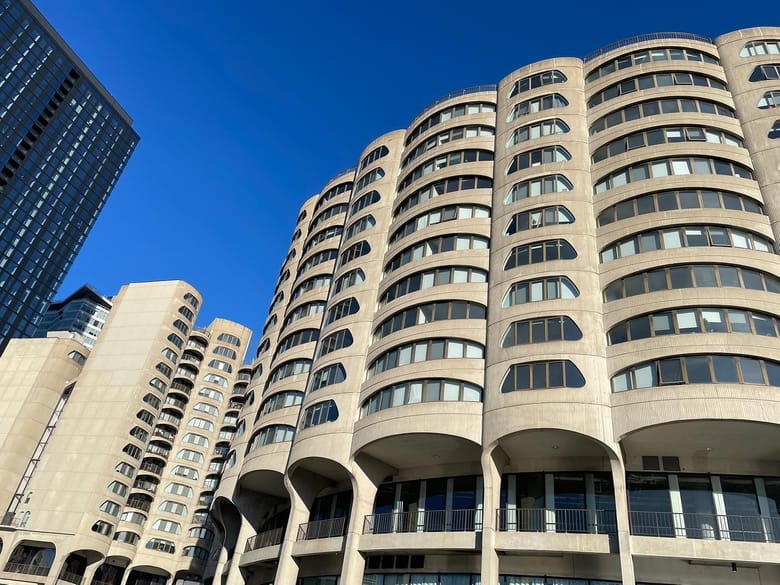 A concrete building with rounded exterior against a bright blue skyline