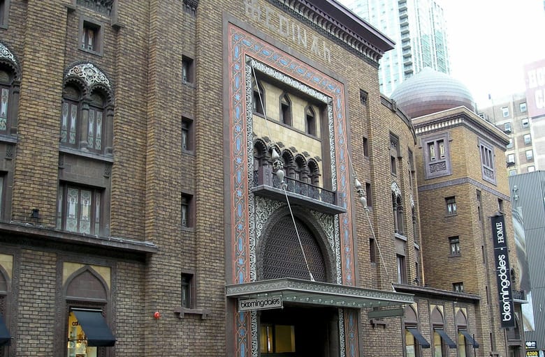 Exterior view of grey brick building with metal flat awning