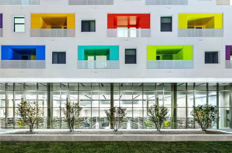 Facade of the Independence Library, a gray building with colorful windows