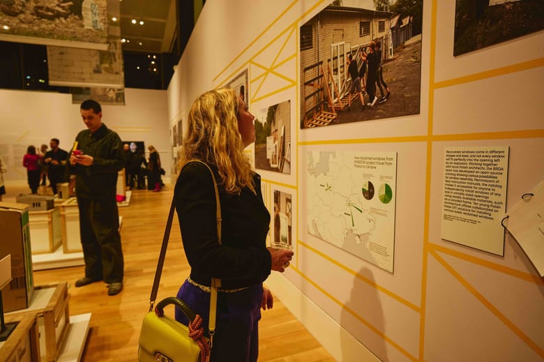 Image of a woman standing and looking at an image on the wall.