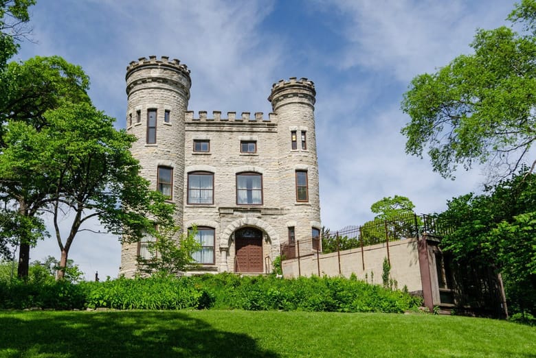 Exterior shot of a small castle amidst greenery