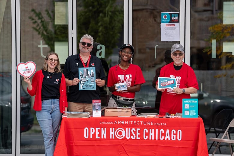 Four people smiling with Open House Chicago signs in hand