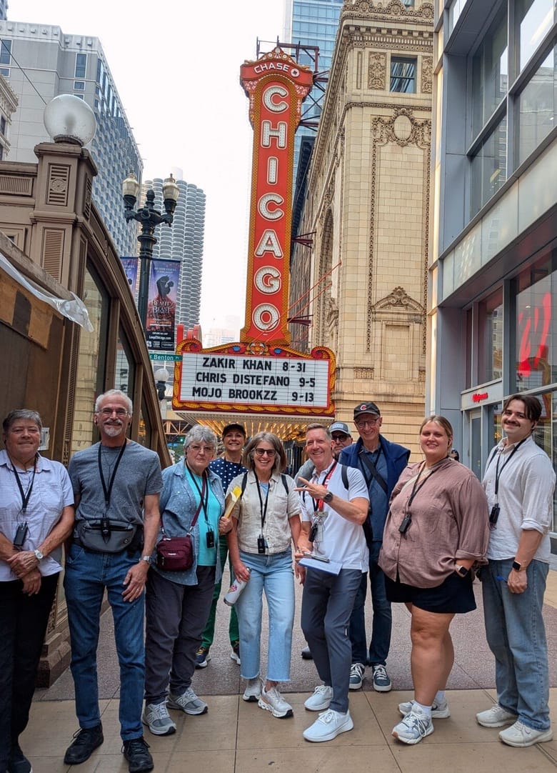 A group of people pose at the Chicago Theatre