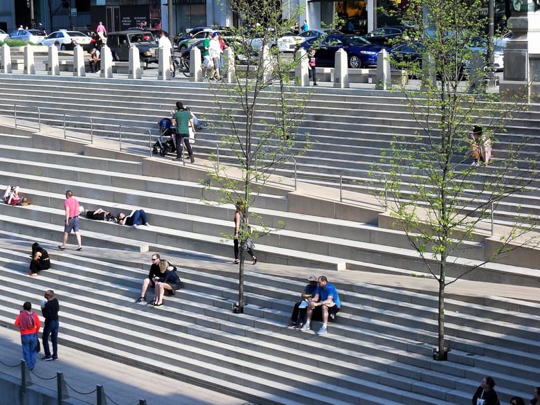 People sitting on many steps. 