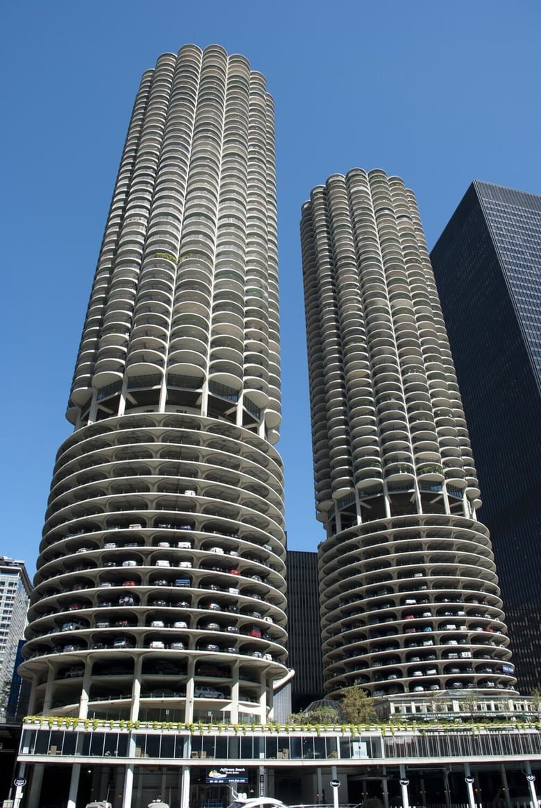 Exterior of two identical cylindrical residential tower buildings with scalloped balconies