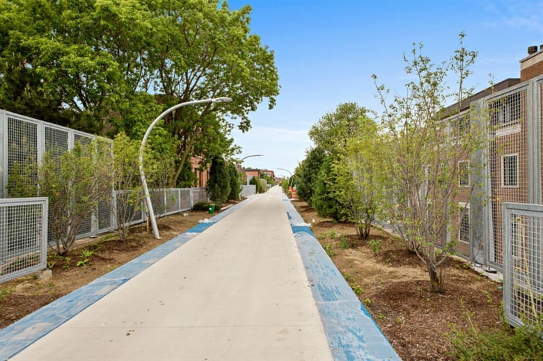View from elevated walking path onto city street. 