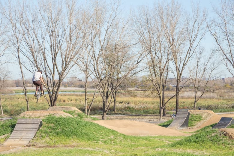 a bike track on a sunny day with trees behind it.