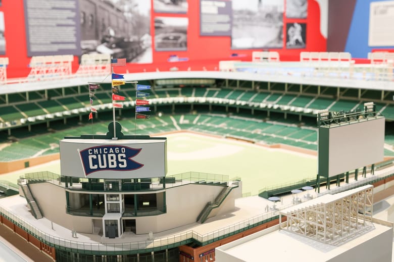 Close up of scale model of a baseball field with green stands and a sign that reads "Chicago Cubs"
